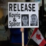 Protest sign calling for the release of Kovrig and Spavor.