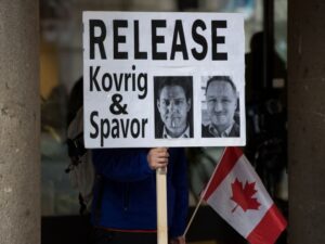 Protest sign calling for the release of Kovrig and Spavor.